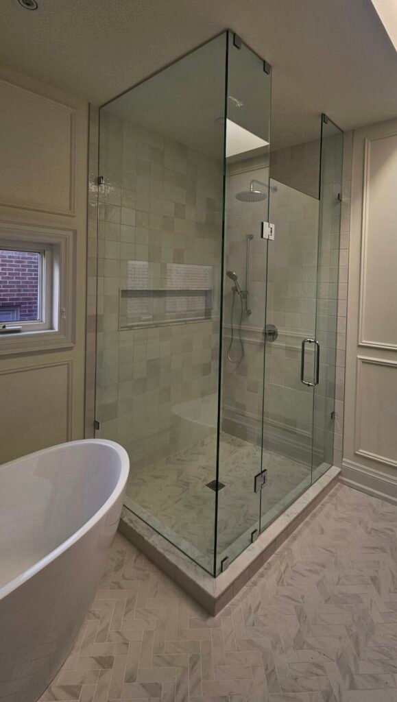 Modern bathroom with a custom corner glass shower, done in Toronto